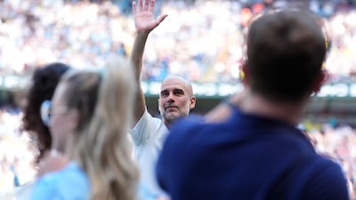 Pep Guardiola waves to fans at the Etihad Stadium. PA