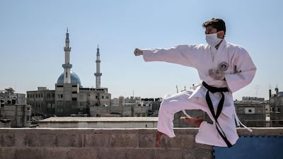 Wael, one of the sons of Palestinian karate coach Khaled Sheikh Eid, trains on the rooftop of his family house at a refugee camp in Rafah in the Gaza Strip, during the novel coronavirus edpidemic crisis. AFP