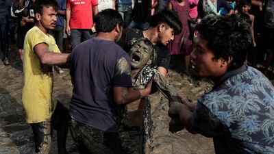 A man reacts after seeing the body of his father in the flooded area beside the Bagmati river following heavy rains in Kathmandu, Nepal. Reuters