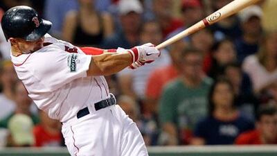 Boston's Cody Ross follows through on a three-run home run against the Chicago White Sox