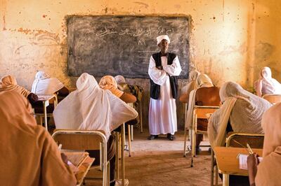 A schoolteacher invigilates pupils during end-of-year exams in the northern Sudanese village of Usli. AFP