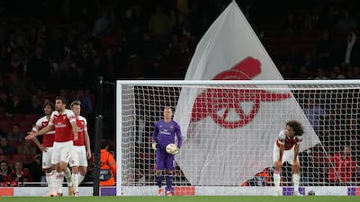 Bernd Leno and his Arsenal teammates look dejected after conceding the second goal scored by Vorskla Poltava's Vyacheslav Sharpar. Reuters