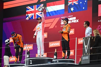 McLaren's Lando Norris and Oscar Piastri flank race winner Max Verstappen on the podium. Getty Images