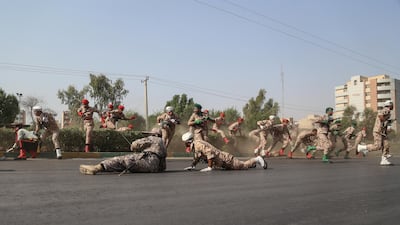 Iranian soldiers, women, and children lay down and run during the attack. EPA