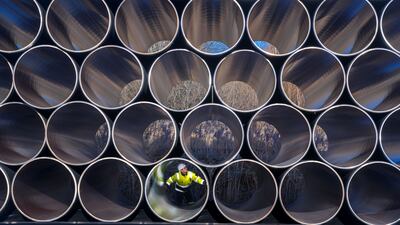 epaselect epa05662430 A worker inspects stacks of pipes weighing several tons each which will be used for the construction of the Nord Stream gas pipeline in the Sassnitz-Mukran harbour in northeastern Germany, 06 December 2016. The first sections of the 1,200 kilometer pipeline were delivered in late October 2016. Around 2,000 of a total 90,000 steal pipe components are currently being stored on the island of Ruegen. According to the Gazprom subsidiary Nord Stream 2 AG, the assembly works will begin in mid-2017. So far the political controversial pipeline, which will have a total capacity of some 55 billion cubic meters, has not recieved building permission. EPA/JENS BUETTNER