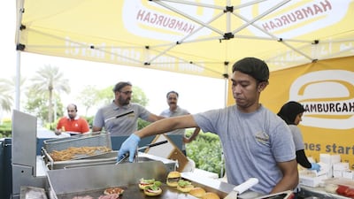 A worker prepares mini burgers at the Hamburgah stand. Sarah Dea / The National
