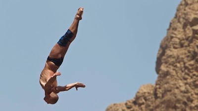 Artem Silchenko, from Russia, dives from a 27m high take-off board during the first round.