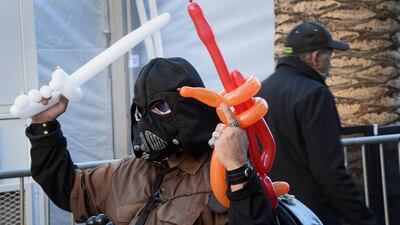 A balloon artist sells balloon light sabres on Hollywood Boulevard before the premiere of Star Wars: The Force Awakens at the TCL Theatre in Hollywood. Paul Buck / EPA