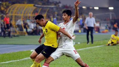 UAE's Mohammed Al Attas, right, challenges Norshahrul Idlan of Malaysia. AP
