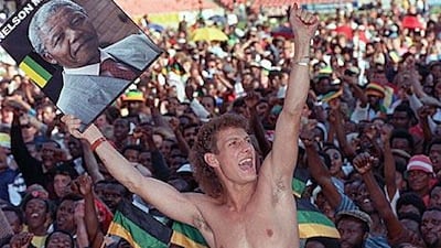 A fan displays a portrait of Nelson Mandela, the anti-apartheid leader, during the Human Rainbow concert at Ellis park, Johannesburg, in March 1990 to celebrate the African National Congress leader's release after 27 years of imprisonment on Robben Island as a political prisoner.