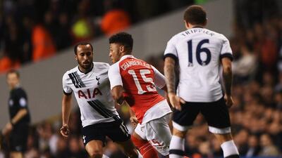 Arsenal's Alex Oxlade-Chamberlain dribbles through Spurs' Andros Townsend and Kieran Trippier during their League Cup clash on Wednesday night. Tom Dulat / Getty Images