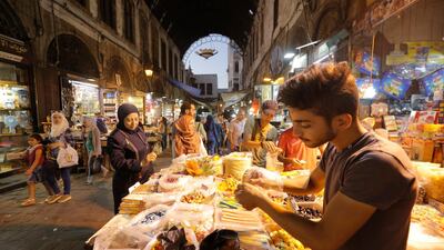 People buy chocolate and candies at al-Hamidiyeh market in the old city of Damascus, Syria two days ahead of Eid al-Adha. EPA