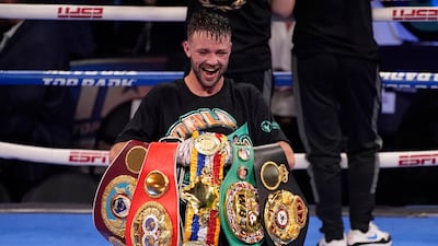 Josh Taylor celebrates with his belts after defeating Jose Ramirez by unanimous decision to unify the division. PA