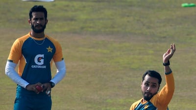 Pakistan's Faheem Ashraf bowls as teammate Hasan Ali watches during a practice session at the Rawalpindi Cricket Stadium. AFP