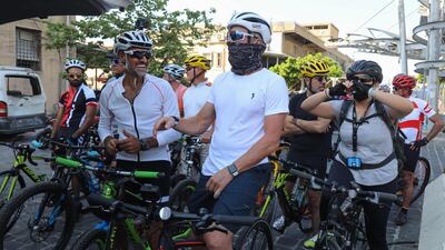US former professional cyclist Lance Armstrong along with Lebanese sportsman Maxime Chaya prepare to lead "Bike for Beirut" charity tour at the site of the August 4 port explosion. AFP