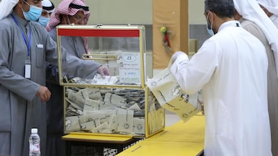 A Kuwaiti judge and his aides count the ballots at a polling station at the end of the parliamentary elections vote, in the Abdullah al-Salem district of Kuwait city. AFP