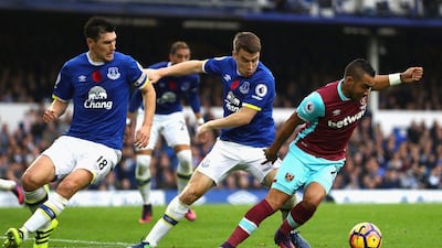 Seamus Coleman of Everton, centre, puts pressure on Dimitri Payet of West Ham United. Michael Steele / Getty Images