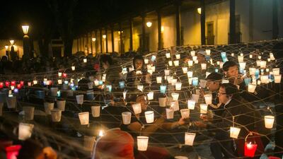 People light candles during the second day of the International Cantoya Festival in Patzcuaro, Michoacan State, Mexico. Enrique Castro / AFP
