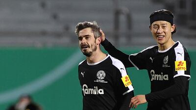 Kiel's Fin Bartels celebrates with Jae-sung Lee after scoring their first goal. AP