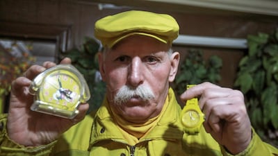 Zakkour shows his yellow watch and clock.