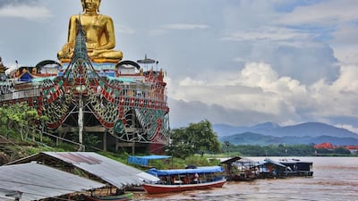A temple on the banks of the Mekong River in the Golden Triangle in Chiang Saen, northern Thailand, historically one of the region’s trade hubs. The golden Buddha is perched on a replica of a ship. Getty Images