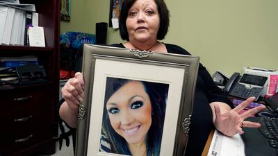 Denise Spears holds a portrait of her late step-daughter Marsha Spears Harbour, a victim of domestic violence, in Meridian, Mississippi, southern US. AP