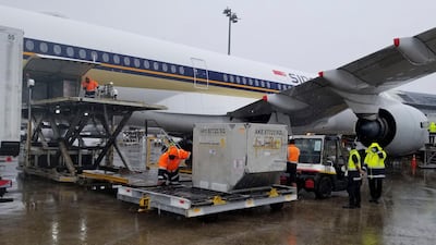 A shipment containing coronavirus vaccines is unloaded from a plane upon arrival in Auckland as New Zealand receives its first batch. New Zealand Ministry of Health via AP