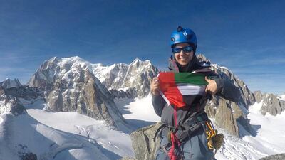 Dolores Al Shelleh, a 27 year old Jordanian living and working in Dubai, displays a UAE flag in the Alps at the summit of a 3,534-metre peak during a winter mountaineering course trip last week. Courtesy Dolores Al Shelleh