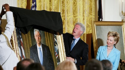 Former president Bill Clinton unveils his portrait as he and former first lady Hillary Clinton participate in a ceremony for the unveiling of the Clinton portraits in 2004. AP