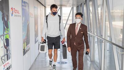 Sakhir Grand Prix winner Sergio Perez is accompanied by Etihad Airways staff at Abu Dhabi Airport.
