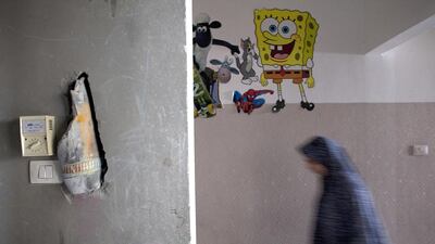Part of an Israeli tank shell is seen still stuck in the wall after it slammed into a home and killed one-year-old Rezak Al Alek in the Tufa neighborhood of central Gaza on July 19,2014 . The baby was in his baby chair when he was killed. His sister Malak says that she was in her bedroom at the time of the attack and when she opened the door all she could see was smoke. Heidi Levine for The National