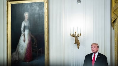President Donald J Trump listens as first lady Melania Trump speaks on a year of historic progress and action combating the opioid crisis in the East Room of the White House on October 24, 2018, in Washington. Getty Images