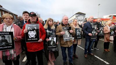 Relatives and supporters of the victims of the 1972 Bloody Sunday killings hold images of those who died as they march from the Bogside area of Derry, Northern Ireland. AFP