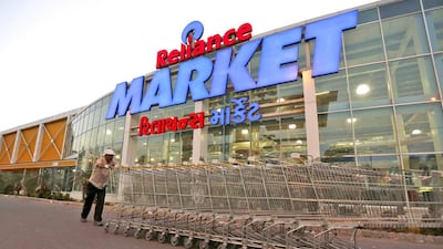 A worker pushes trolleys outside the Reliance Market superstore in Ahmedabad. India is still a relatively untapped market for global retailers and presents a huge opportunity. Amit Dave / Reuters