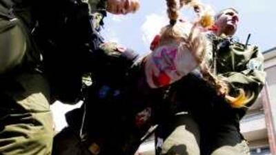 Police detain a would-be squatter during a rally at the closed Tempelhof airport.