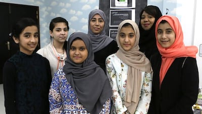 From left: Emirati Nada Obaid, 12, Egyptian Rawan Hagras, 16, Emirati Moza Alshamsi, 12, Iraqi Hajer Alanzi, 23, Emirati Alia Helal, 13, Hedaya Al Ali, National Talent general manager, and Emirati Wasayef Saif Altinijy, 12, who participated in the social media classes at Falaj Al Mualla Girls Centre. Jeffrey E Biteng / The National