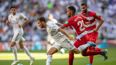Real Madrid's Eden Hazard, left, runs with the ball against Granada. AP