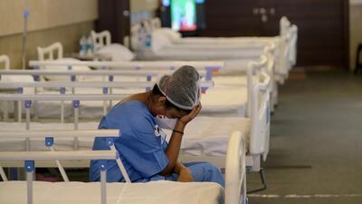 A nurse rests in a ward at an emergency Covid-19 centre set up in New Delhi, India. Bloomberg