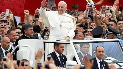 Pope Francis arrives to celebrate a mass at Mother Teresa square in central Tirana yesterday. He hailed Muslim-majority Albania as an “inspiring example” of religious harmony. Gent Shkullaku / AFP