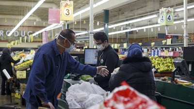 Two customers place their groceries in their cart while checking out at Greenland Market on the first day of Ramadan on April 23, 2020 in Dearborn Heights, Michigan. Getty Images via AFP