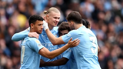 Erling Haaland of Manchester City celebrates with teammates after his shot was defected in for the first goal in the 5-1 Premier League win against Luton Town at the Etihad Stadium on Saturday, April 13, 2024. Getty Images