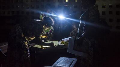 Polling station officials at the Pierre Ntsiete Primary School in Brazzaville prepare to close the polling stations during the vote for the presidential election. Eduardo Soteras / AFP