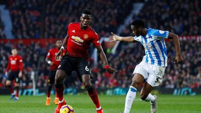 Pogba in action with Huddersfield Town's Terence Kongolo. Action Images via Reuters