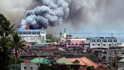 Black smoke comes from a burning building in a commercial area of Osmena street in Marawi city, Philippines. Romeo Ranoco / Reuters