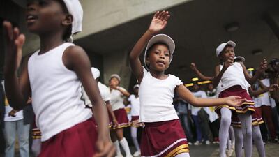 Young South African girls dance during the memorial service for the late South African President Nelson Mandela at the First National Bank (FNB) Stadium in Soweto, Johannesburg. Dai Kurokawa / EPA