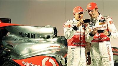 Lewis Hamilton, left, and Jenson Button and compare pictures at the launch of the McLaren-Mercedes MP4-25 Formula One car at Newbury yesterday. The pair will go head-to-head for the same team this season.