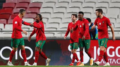 Renato Sanches, second left, is congratulated by teammate Cristiano Ronaldo, left, after scoring his team's third goal. AP