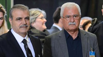 Members of the Syria's main opposition group, Asaad Zoabi (left) and George Sabra (right) arrive to attend Syrian peace talks at the United Nations (UN) Offices in Geneva on February 1. / AFP / FABRICE COFFRINI