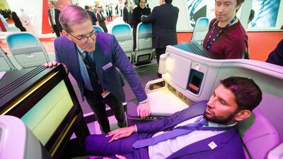 Visitors test out the new Boeing business class seat. Leslie Pableo for The National