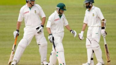 Three at the crease: South Africa captain Graeme Smith, left, talks to Neil McKenzie and Hashim Amla, right, while acting as McKenzie's runner during the first Test match at Lord's.